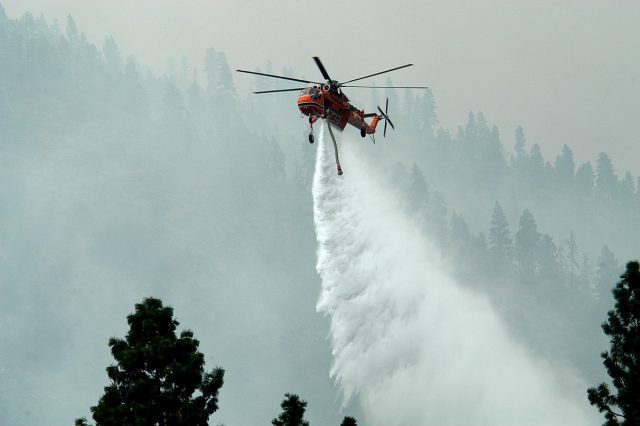 A helicopter fighting yet another raging wildfire