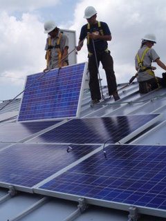 Julio Cardoza (middle), an LCTN solar installation trainee, worked with the South Coast Solar staff as “lead installer” on Wednesday’s installation