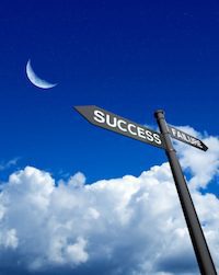 An image of a road sign pointing one direction as "success" and the other side as "failure." 