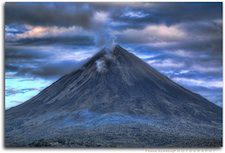 The amount of greenhouse gases emitted by even a large and ongoing volcanic eruption is miniscule compared to industrial and automotive carbon emissions caused by human activity. Global warming can, however, help trigger volcanic eruptions by melting the ice that keeps rock from turning to magma. Pictured: The Arenal Volcano in Costa Rica, one of the 10 most active volcanoes in the world