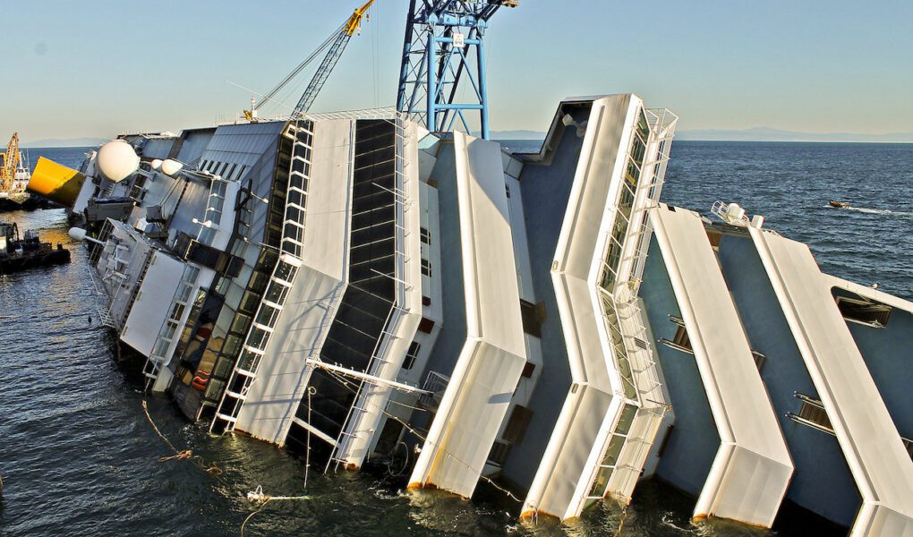The cruise ship Costa Concordia sets wrecked and partially submerged on its side