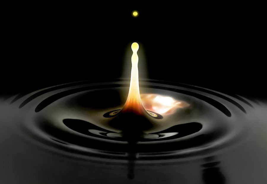An image of a glowing hot drop of oil rising from a black pool