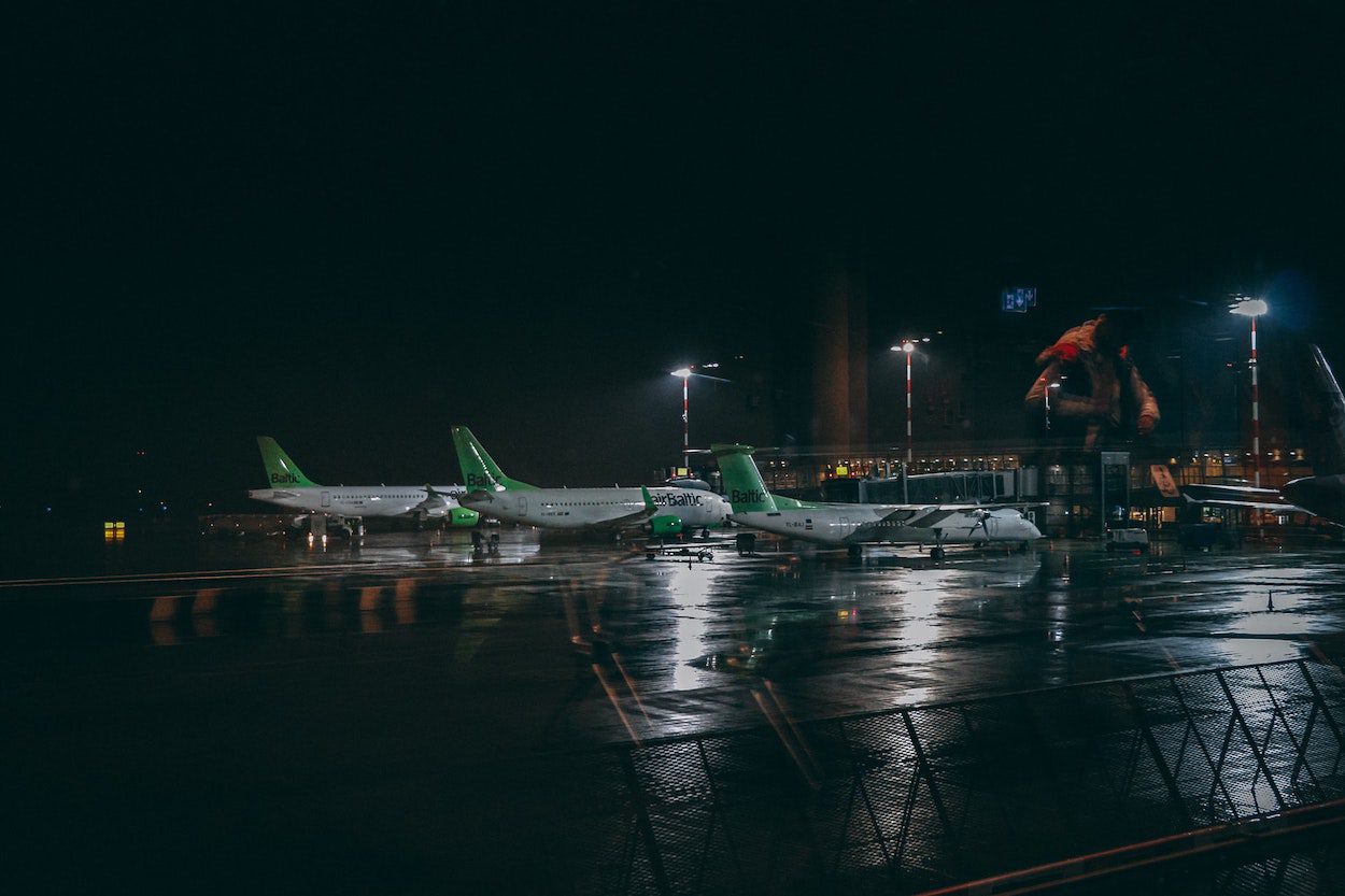 Airlines waiting on the tarmac on a rainy evening