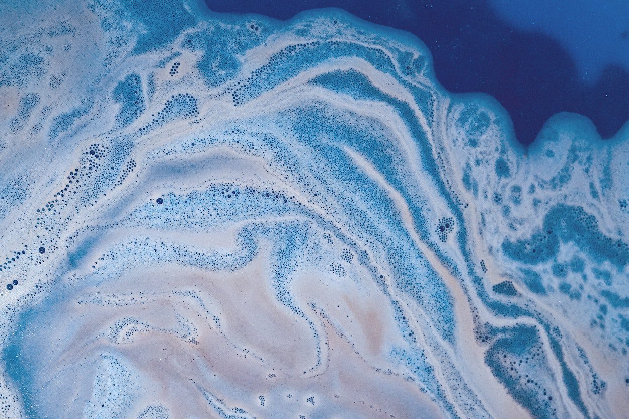 Oil swirls in an ocean wave.