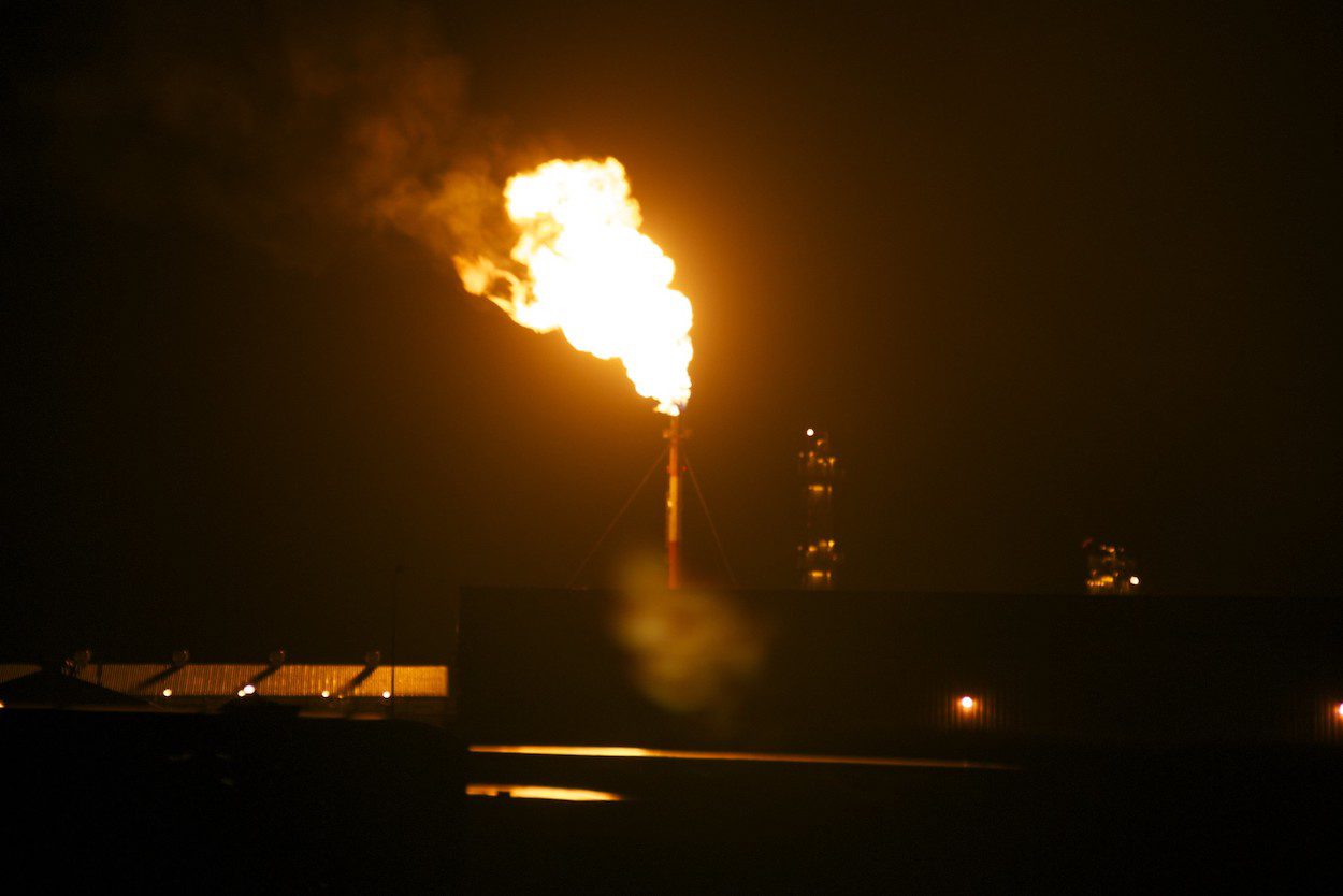 A methane gas flare at night in an oil field in North Dakota