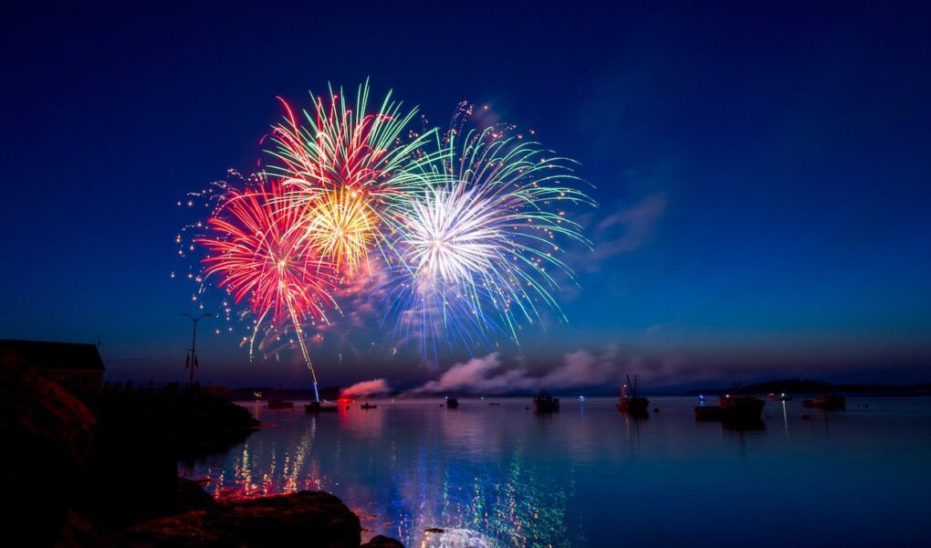 A fireworks display over water