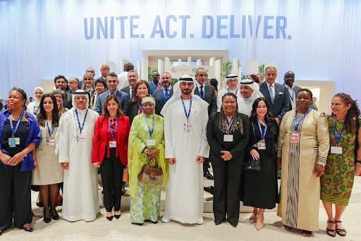 COP28 delegates stand for a photo after adoption of the Emirates Declaration on Culture-Based Climate Action